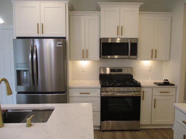 6 Royal Ct, Horseheads, NY 14845 - kitchen with appliances with stainless steel finishes, dark wood-style floors, white cabinetry, backsplash, and light stone counters