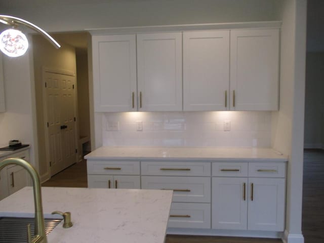 6 Royal Ct, Horseheads, NY 14845 - kitchen featuring white cabinetry, tasteful backsplash, light stone countertops, and a sink