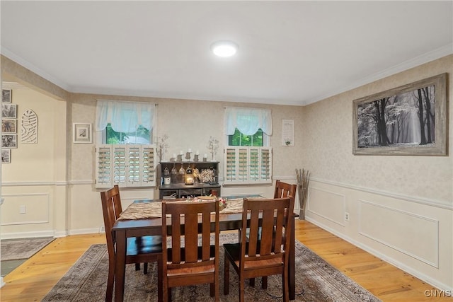 223 Windcrest Dr, Camillus, NY 13031 - dining space with a decorative wall, wood finished floors, ornamental molding, and wainscoting
