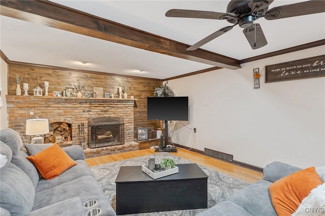 223 Windcrest Dr, Camillus, NY 13031 - living room with wood finished floors, a ceiling fan, beamed ceiling, a brick fireplace, and crown molding