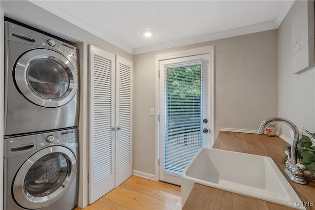 223 Windcrest Dr, Camillus, NY 13031 - laundry room with stacked washer / drying machine, light wood-style floors, and ornamental molding