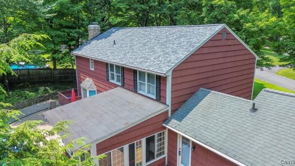 223 Windcrest Dr, Camillus, NY 13031 - view of property exterior with a chimney and a shingled roof