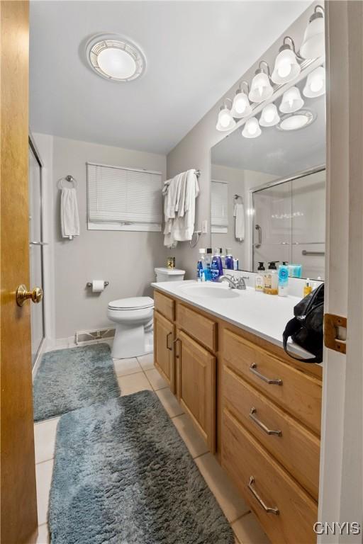 123 Hillcrest Rd, Onondaga, NY 13219 - full bathroom with tile patterned floors, a shower stall, vanity, and toilet