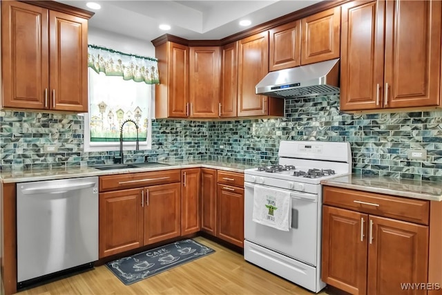 87 Burch Ave, West Seneca, NY 14210 - kitchen featuring stainless steel dishwasher, gas range gas stove, under cabinet range hood, a sink, and light countertops