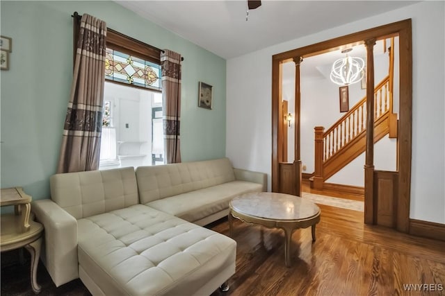87 Burch Ave, West Seneca, NY 14210 - living room with wood finished floors, a chandelier, stairs, and baseboards