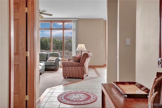 8770 Old State Rd, Allen, NY 14709 - sitting room with light tile patterned floors, ceiling fan, baseboards, and inlaid floor details