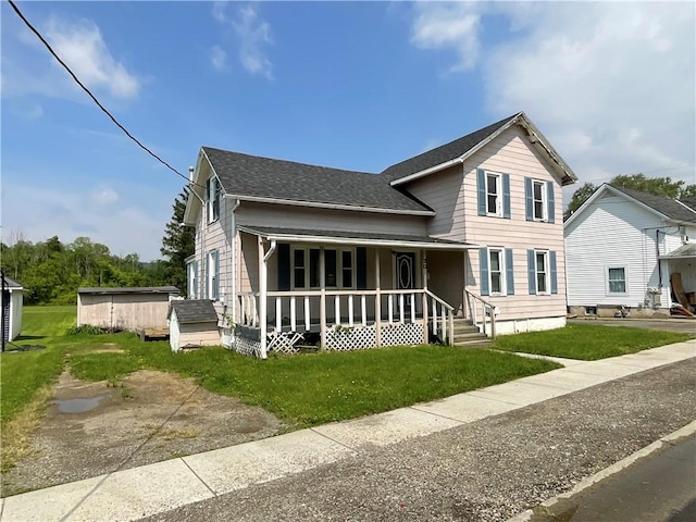 201 S Main St, Wayland, NY 14572 - view of front facade with a porch, a shingled roof, and a front yard