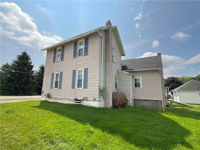 201 S Main St, Wayland, NY 14572 - back of property with a chimney, oil tank, and a lawn