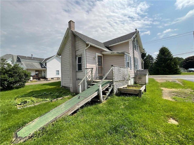 201 S Main St, Wayland, NY 14572 - view of side of property with a chimney and a lawn