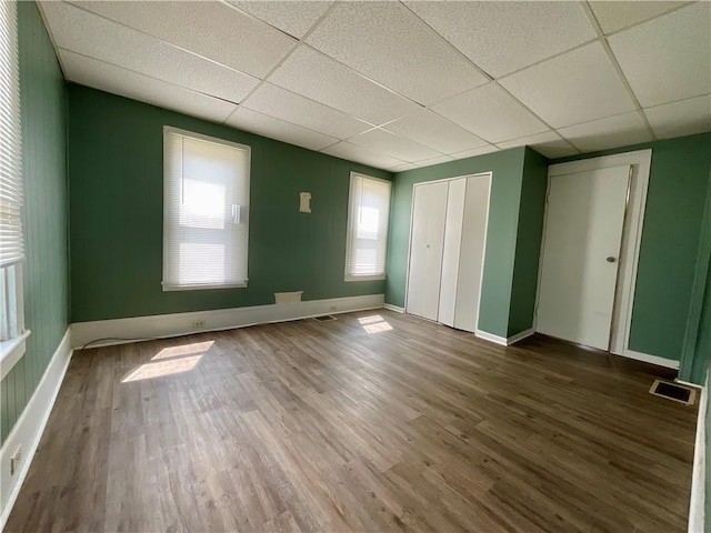 201 S Main St, Wayland, NY 14572 - unfurnished bedroom featuring a drop ceiling, wood finished floors, baseboards, and a closet
