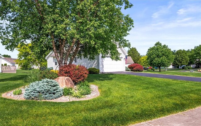 14 Glenn Hvn, Ogden, NY 14559 - view of front of home with driveway, a front lawn, and a garage