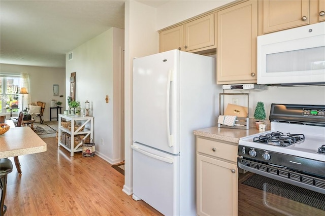 14 Glenn Hvn, Ogden, NY 14559 - kitchen featuring white appliances, light wood-type flooring, cream cabinetry, light countertops, and baseboards