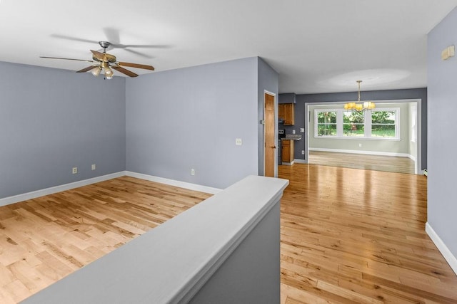 26 Prospect St, Delhi, NY 13753 - spare room featuring a chandelier, light wood-type flooring, baseboards, and ceiling fan