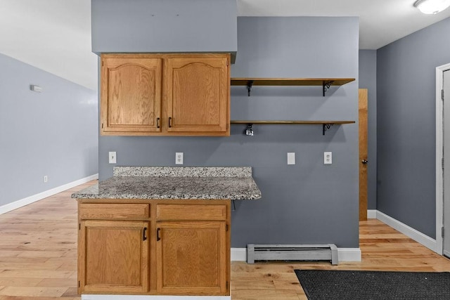 26 Prospect St, Delhi, NY 13753 - kitchen featuring a baseboard radiator, light wood finished floors, baseboards, open shelves, and stone countertops