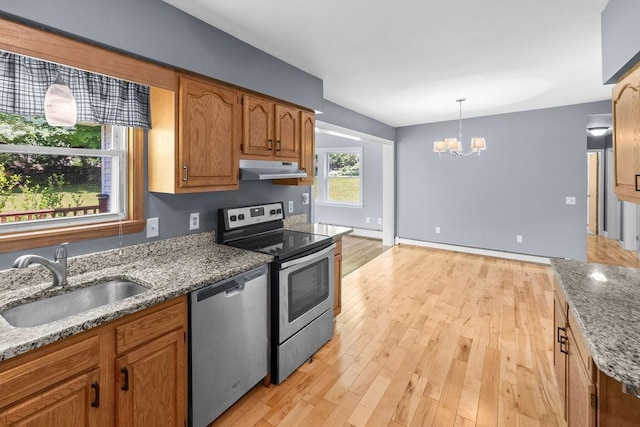 26 Prospect St, Delhi, NY 13753 - kitchen featuring stainless steel appliances, a sink, under cabinet range hood, a baseboard heating unit, and a chandelier