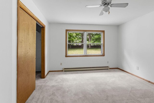 26 Prospect St, Delhi, NY 13753 - unfurnished bedroom with baseboard heating, carpet floors, baseboards, and ceiling fan