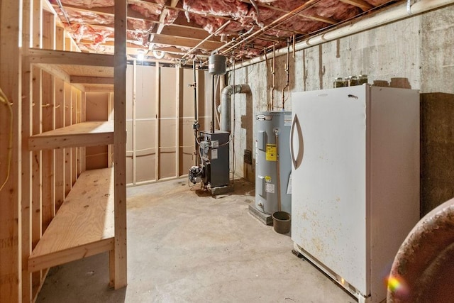 26 Prospect St, Delhi, NY 13753 - unfinished below grade area with water heater, a heating unit, and freestanding refrigerator