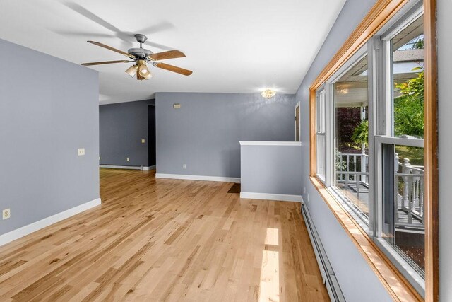 26 Prospect St, Delhi, NY 13753 - empty room featuring healthy amount of natural light, light wood-style flooring, a baseboard heating unit, and baseboards