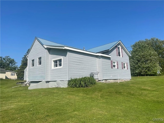 8807 N Main St, Le Ray, NY 13637 - view of property exterior with a yard and metal roof