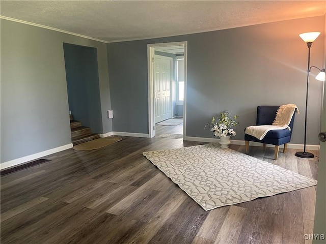 8807 N Main St, Le Ray, NY 13637 - living area with dark wood-style floors, baseboards, stairs, crown molding, and a textured ceiling