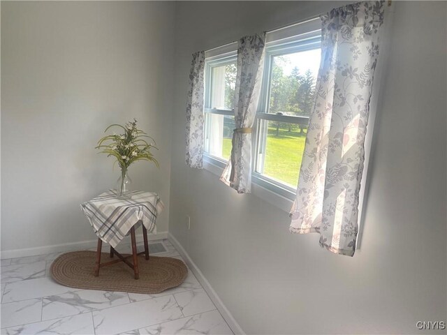 8807 N Main St, Le Ray, NY 13637 - unfurnished room featuring marble finish flooring, healthy amount of natural light, and baseboards