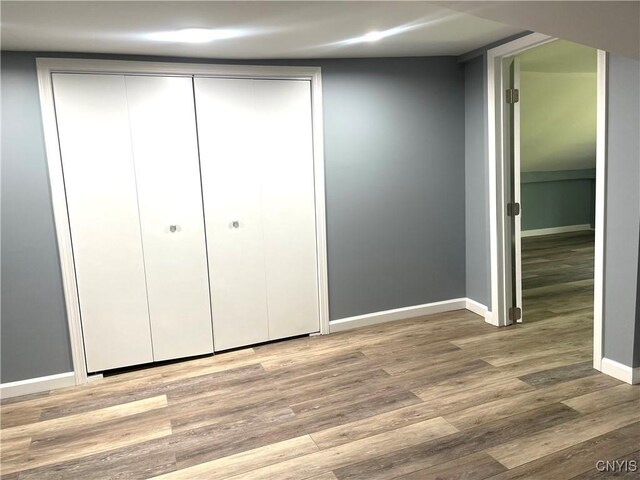 8807 N Main St, Le Ray, NY 13637 - unfurnished bedroom with wood finished floors, baseboards, and a closet