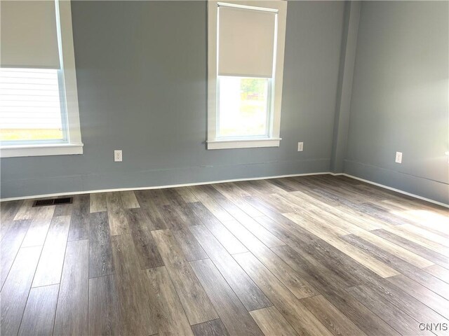 8807 N Main St, Le Ray, NY 13637 - unfurnished room with healthy amount of natural light, dark wood-type flooring, and baseboards