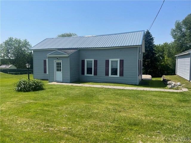 8807 N Main St, Le Ray, NY 13637 - rear view of property with a lawn and metal roof