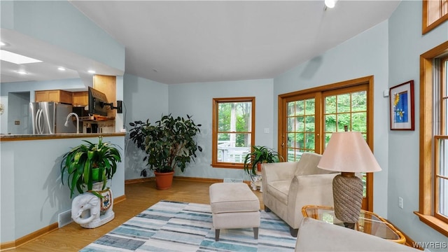 43 Larned Ln, Orchard Park, NY 14127 - living room featuring wood finished floors, a skylight, and recessed lighting