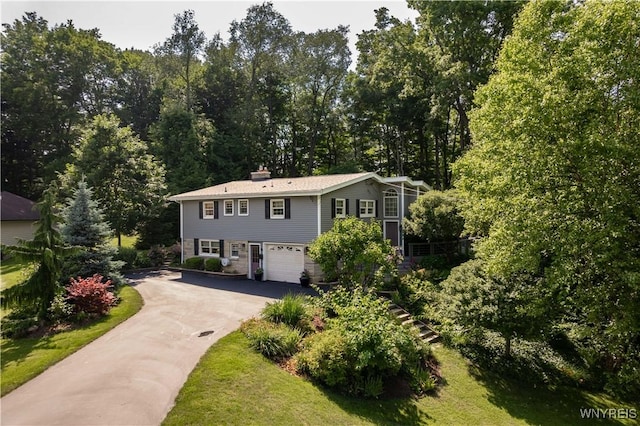 43 Larned Ln, Orchard Park, NY 14127 - view of front of property featuring driveway, a garage, and a chimney
