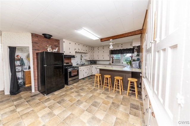 7750 State Route 812, New Bremen, NY 13367 - kitchen featuring stainless steel appliances, white cabinets, light countertops, a breakfast bar, and a peninsula