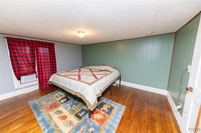 7750 State Route 812, New Bremen, NY 13367 - bedroom featuring wood finished floors, baseboards, and an AC wall unit