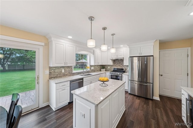 9377 Juniper Pl, Clarence, NY 14032 - kitchen with stainless steel appliances, dark wood-style floors, decorative backsplash, white cabinets, and baseboards