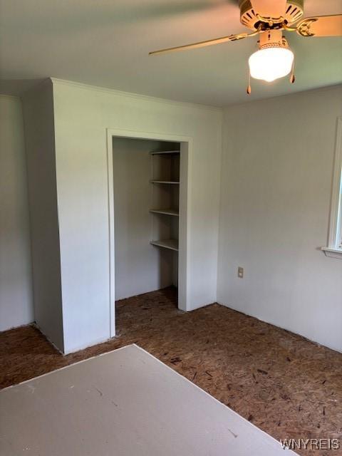 7491 S Grove Rd, Lyndon, NY 14737 - unfurnished bedroom featuring a closet and ceiling fan