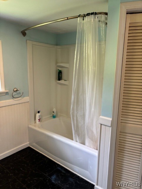 7491 S Grove Rd, Lyndon, NY 14737 - bathroom featuring shower / tub combo with curtain, wainscoting, and a closet