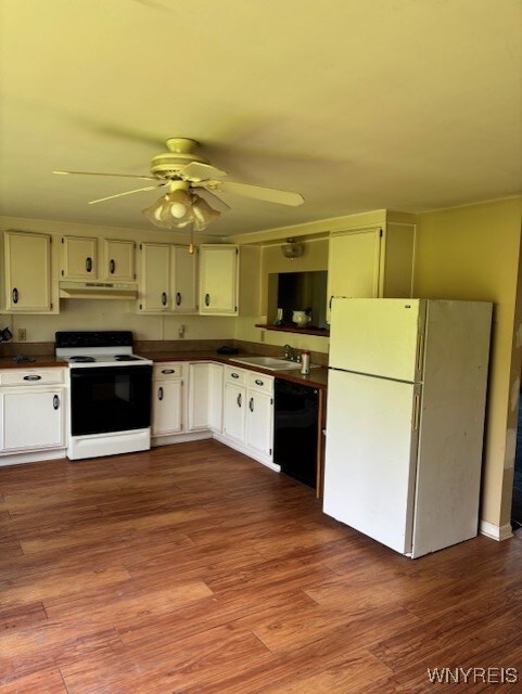 7491 S Grove Rd, Lyndon, NY 14737 - kitchen with white appliances, under cabinet range hood, dark countertops, a sink, and a ceiling fan