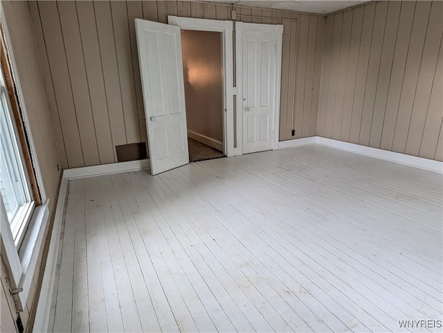 11131 Lakeshore Rd, Yates, NY 14098 - unfurnished bedroom featuring hardwood / wood-style flooring and wood walls