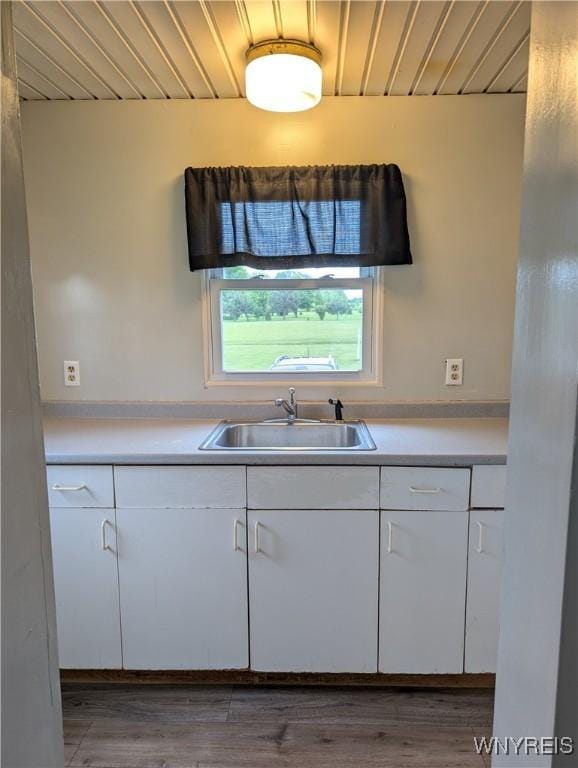 11131 Lakeshore Rd, Yates, NY 14098 - kitchen with a sink, white cabinets, light countertops, wood finished floors, and wood ceiling
