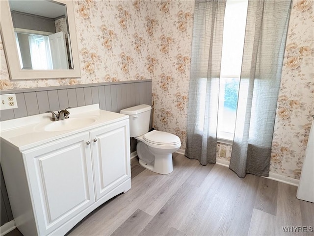 11131 Lakeshore Rd, Yates, NY 14098 - bathroom with wallpapered walls, wood finished floors, toilet, and vanity