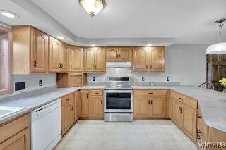 3271 Rte 78, Wethersfield, NY 14024 - kitchen featuring stainless steel range, dishwasher, ventilation hood, a peninsula, and light countertops