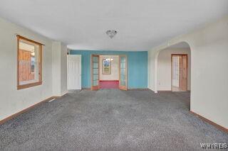 3271 Rte 78, Wethersfield, NY 14024 - unfurnished room featuring baseboards, arched walkways, and carpet flooring