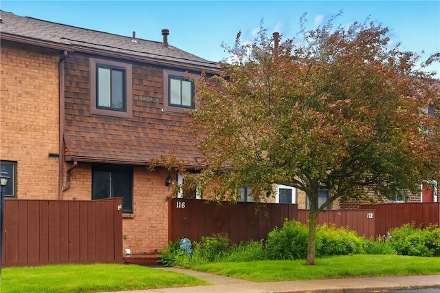116 Surrey Hill Way, Henrietta, NY 14623 - view of home's exterior featuring brick siding and roof with shingles