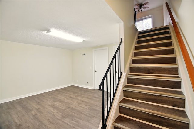 116 Surrey Hill Way, Henrietta, NY 14623 - stairway featuring wood finished floors, a textured ceiling, and baseboards
