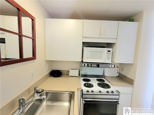 35 Miller Park, Chautauqua, NY 14722 - kitchen with white appliances, light countertops, a sink, and white cabinets