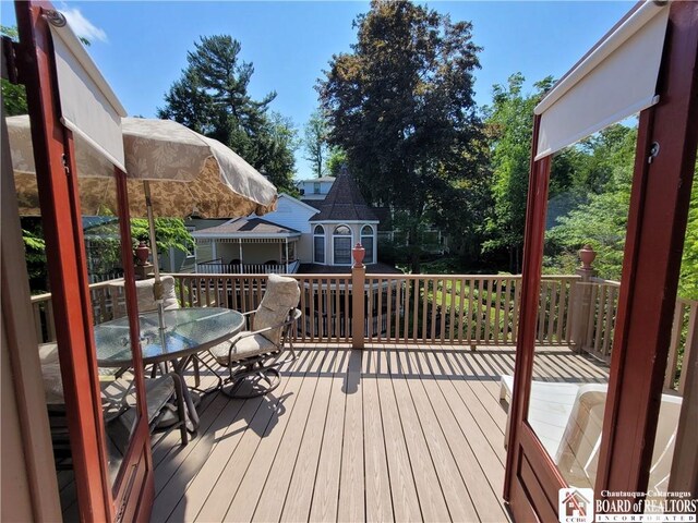 35 Miller Park, Chautauqua, NY 14722 - wooden deck featuring outdoor dining space and an outdoor structure
