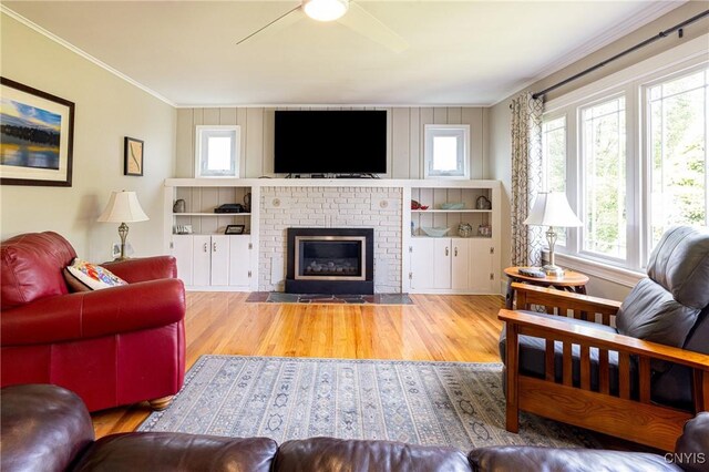 60 E Elizabeth St, Skaneateles, NY 13152 - living area featuring wood finished floors, ceiling fan, a fireplace, and crown molding