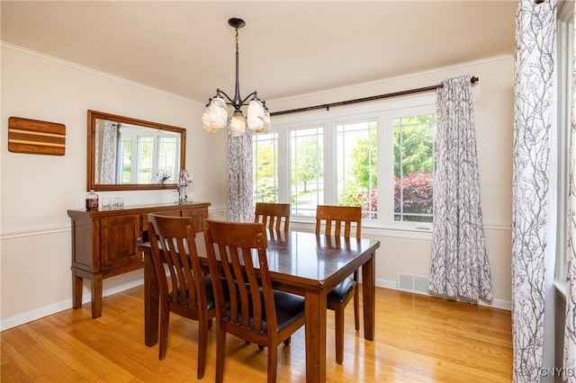 60 E Elizabeth St, Skaneateles, NY 13152 - dining space featuring plenty of natural light, a chandelier, light wood-type flooring, and ornamental molding