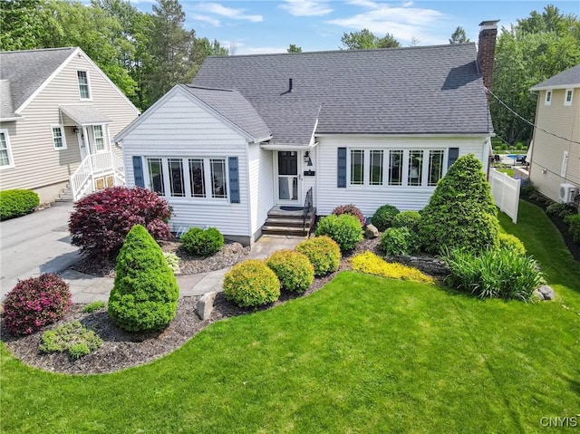 60 E Elizabeth St, Skaneateles, NY 13152 - view of front facade with a chimney and roof with shingles