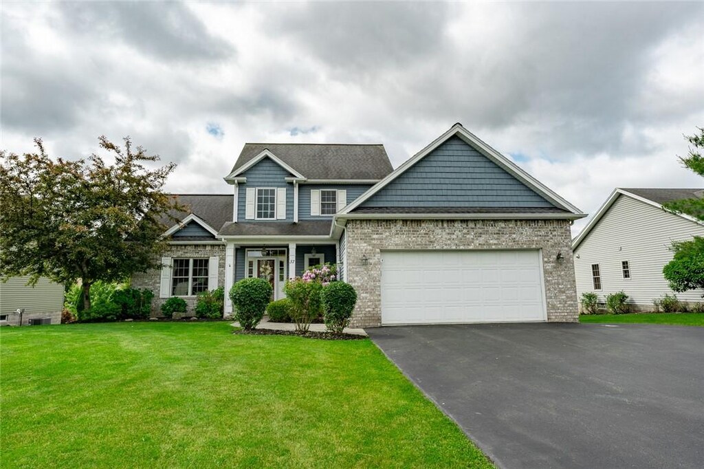 37 Peaceful Harbor Ln, Penfield, NY 14580 - craftsman-style house featuring asphalt driveway, an attached garage, and a front yard