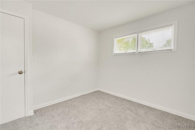 126 Pryor Ave, Tonawanda, NY 14150 - carpeted spare room featuring baseboards